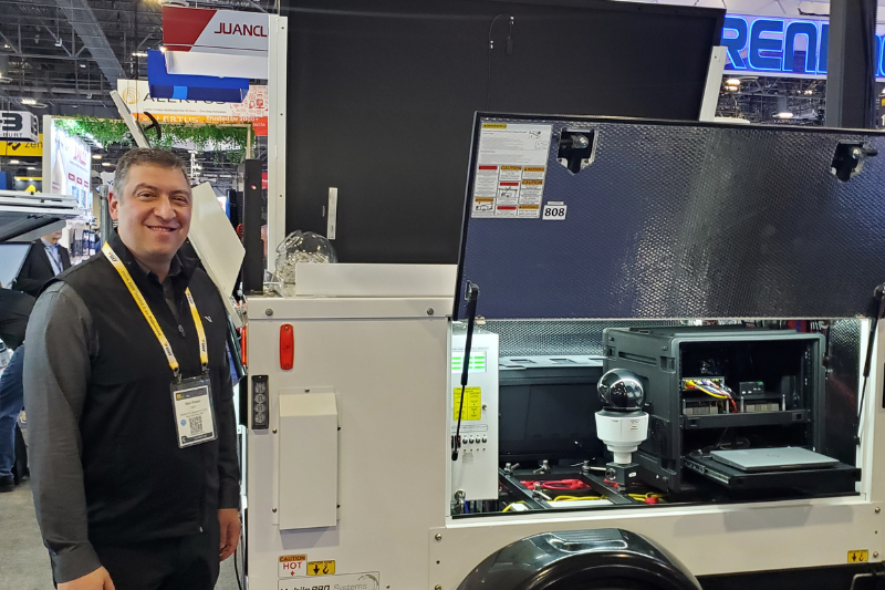 Sam Rosen, CEO, Mobile Pro Systems, stands besides Commander 3400 mobile surveillance trailer at ISC West 2025.